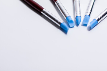Brushes for artistic creation on a white background. The working ends are directed towards each other.