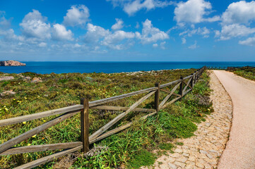 Fototapeta na wymiar coast of Sagres with hiking trail and wooden balustrade, Algarve, Portugal, Europe