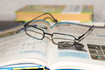 Children's glasses for vision lying on the book