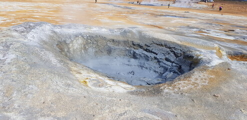 Hverir geothermal area in the north of Iceland near Lake Myvatn, with geothermal lake, looking like Blue Lagoon, Hot Mud Pots and great landscape in the Geothermal Area Hverir, summer day.
