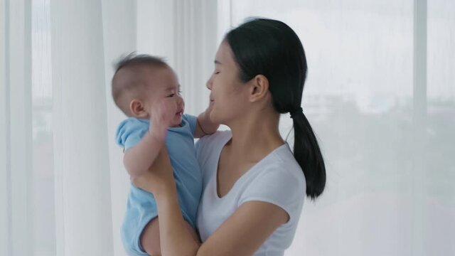 Family concept. Mom was kissing the baby's cheek in the house. 4k Resolution.