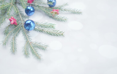 Soft lights background for christmas with fir branches, balls and stras, copy space