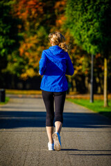 Healthy lifestyle - woman running in city park
