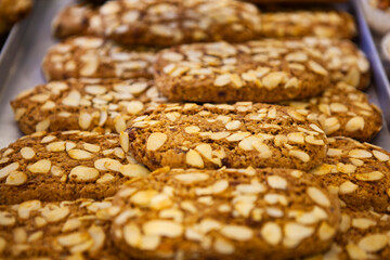The Italian traditional cookies (biscuits) with nuts (hazelnut, peanut, walnut), butter, milk and chocolate chips at the local bakery in Bergamo, Lombardy, Italy. European food and sweets.