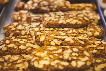 The Italian traditional cookies (biscuits) with nuts (hazelnut, peanut, walnut), butter, milk and chocolate chips at the local bakery in Bergamo, Lombardy, Italy. European food and sweets.