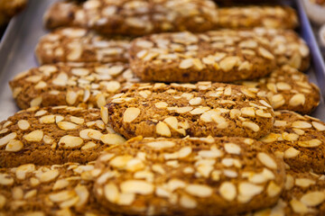 The Italian traditional cookies (biscuits) with nuts (hazelnut, peanut, walnut), butter, milk and chocolate chips at the local bakery in Bergamo, Lombardy, Italy. European food and sweets.
