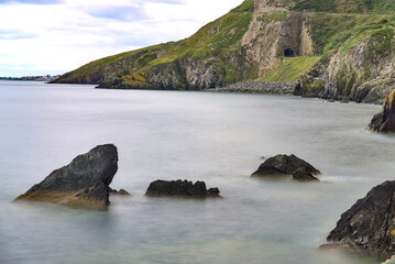 Fototapeta na wymiar Bray to Greystones Cliff Walk. Long-exposure shot of coastal line in Bray, Co. Wicklow, Ireland 