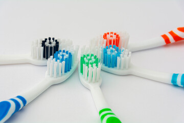 Multi-colored toothbrushes with bristles of bright color on a white background. Banner for your...