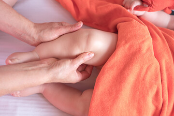 A professional masseur makes a finger massage to baby. Manual therapy. Wellness and therapeutic...