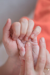 Obraz na płótnie Canvas Fingers massage for newborn baby for speech development. This tactile gymnastics contributes to flow of impulses to brain. Develops attention, memory, coordination, development of speech, creativity.