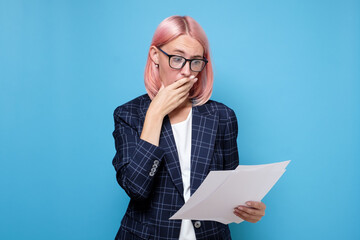 Shocked, funny looking business woman, can not believe her eyes reading financial documents