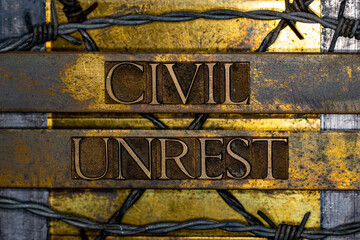 Civil Unrest text message on textured grunge copper and vintage gold background with barbed wire