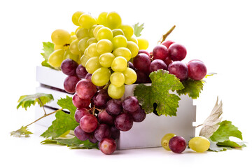 Green and pink grapes with leaves in a white box. isolate on white background