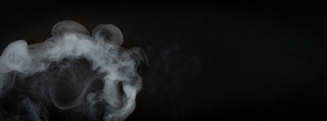 smoke over black leather background copy space