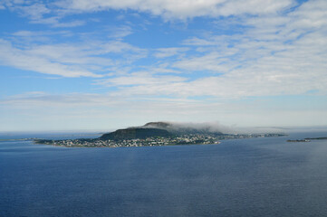 Obraz premium A small island in the morning clouds in the middle of the open sea (Norway)