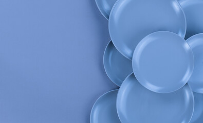 blue kitchen ceramic plates isolated on abstract blue background