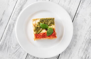 Portion of lasagne on white plate