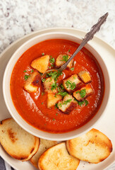 Overhead view of vegan tomato soup with croutons
