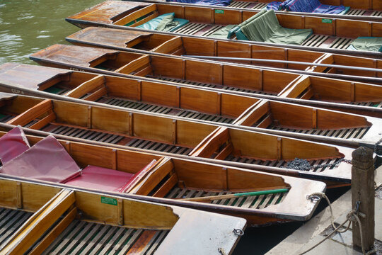 Rows of boats called punts lined up on the River Cam in Cambridge