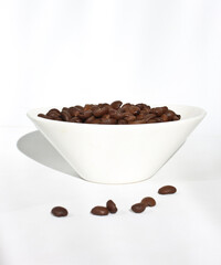 Coffee beans are in a small bowl