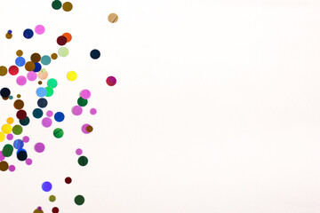 Glittery circles on a white background with space for text. Scattered glitter creates a creative texture.