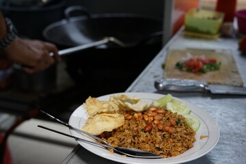 Chef preparing fried rice with fried egg at street food market
