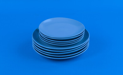 blue kitchen ceramic plates isolated on abstract blue background