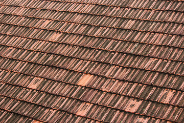 Texture of lines of terracotta tiles on the roof of a building