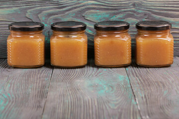 Apple jam in jars. On brushed boards, painted black and white.
