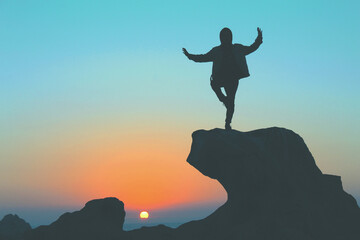 silhouette of a person on a mountain top