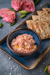 Cheese cream snack with smoked salmon with pita bread. Natural delicious food. Greek cuisine menu. Still life in a marine style on a blue background.