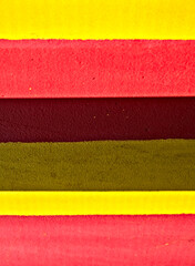 Pattern of wide red and yellow stripes, saturated and subdued.