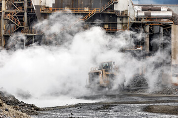 The big bulldozer and industrial pollution. Pollution is the introduction of contaminants into the...