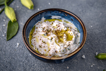 Tzatziki sauce from sour cream cucumbers and herbs. Natural delicious food. Greek cuisine menu....