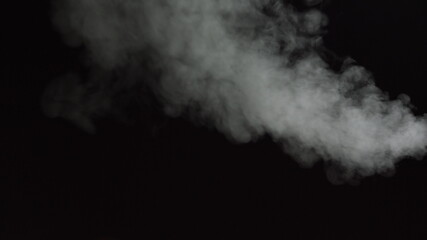 White water vapour on a black background. Close-up shot. White Fume Slowly Floating Rises Up. Abstract Haze Cloud. Animation Mist Effect. Smoke Stream Effect 4K