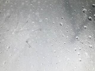 texture of silvery color. plastic wrap with drops of steam on top. unusual natural texture,...