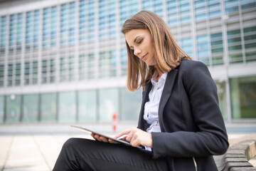 Woman using a tablet out of her office