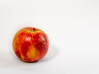 Juicy red and yellow apple close up on white background isolated