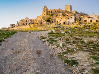 Fototapeta na wymiar Dramatic view of Craco ruins, ghost town abandoned towards the end of the 20th century due to natural disaster, Basilicata region, southern Italy 