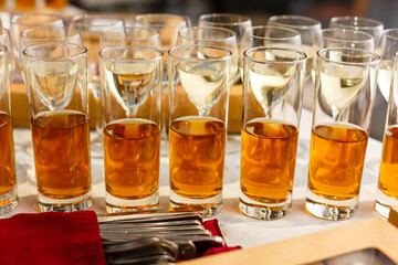 Restaurant serving, glasses with wine and juice in a row