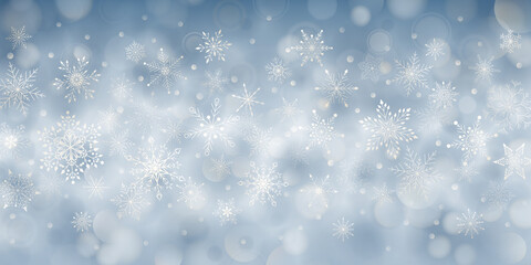 Christmas background of complex big and small falling snowflakes in light blue colors with bokeh effect