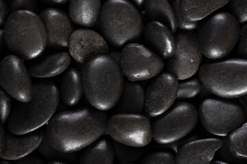 Black river stones texture and background.