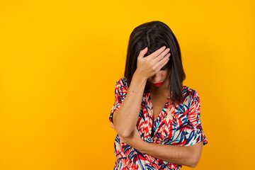 Indoor portrait of beautiful woman with stylish haircut, wearing casual clothes, making facepalm...
