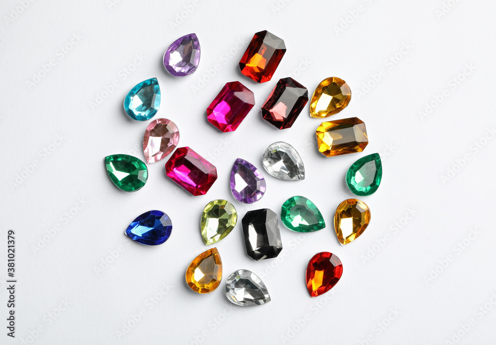 Wall mural Different beautiful gemstones on white background, top view