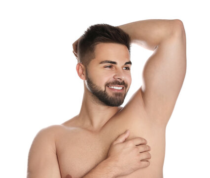 Young man showing hairless armpit after epilation procedure on white background
