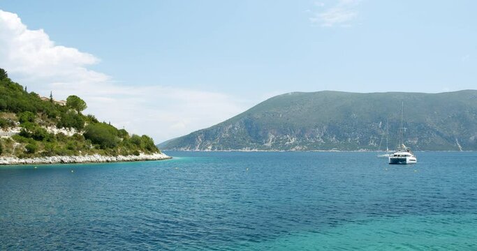 Beautiful landscape with green forest and emerald water lagoon of Foki Fiskardo beach, Kefalonia, Ionian islands, Greece.