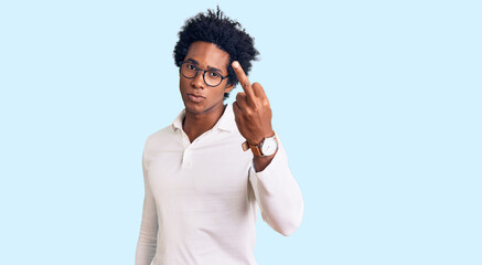 Handsome african american man with afro hair wearing casual clothes and glasses showing middle...