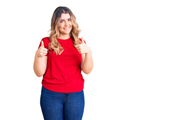 Obraz na płótnie Canvas Young caucasian woman wearing casual clothes success sign doing positive gesture with hand, thumbs up smiling and happy. cheerful expression and winner gesture.