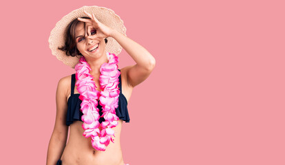 Beautiful young woman with short hair wearing bikini and hawaiian lei smiling happy doing ok sign with hand on eye looking through fingers
