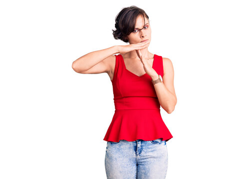 Beautiful young woman with short hair wearing casual style with sleeveless shirt doing time out gesture with hands, frustrated and serious face